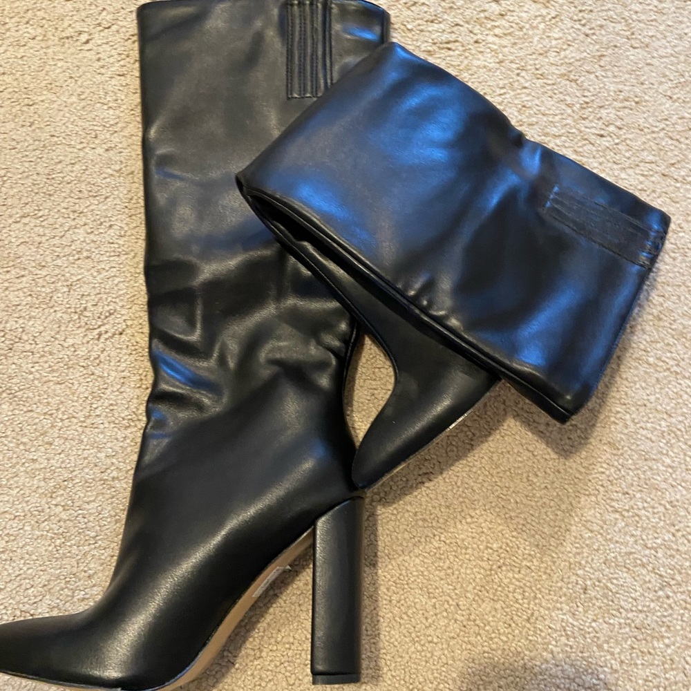Black leather heeled knee high boots